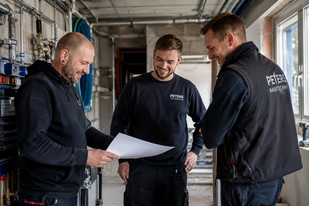 Team von Peters Haustechnik bei der Planung auf der Baustelle